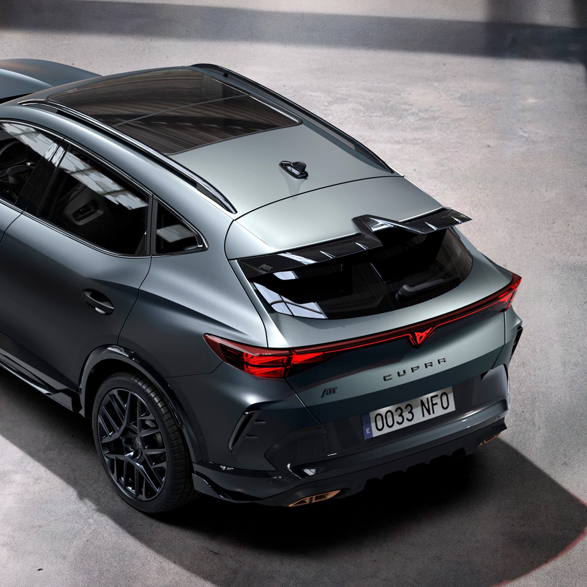 Rear‑side view from a high angle of the CUPRA Formentor, revealing Custom Pack details such as the aggressive rear wing spoiler and rear air curtains.